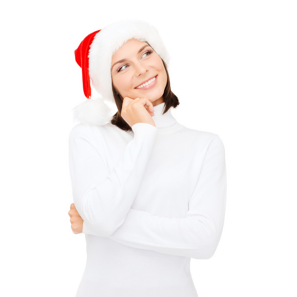 Thinking and smiling woman in santa helper hat - Фото, изображение