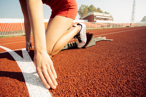 Detailed view of a female sprinter in the starting blocks - Foto, immagini