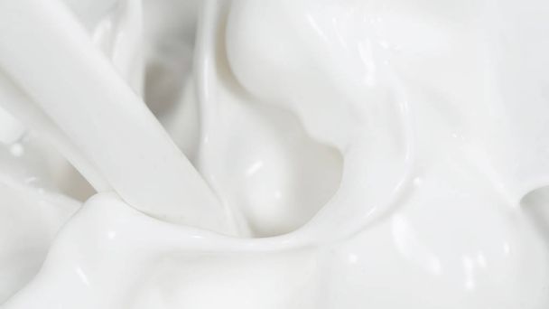 Macro shot of pouring cream in detail - Фото, изображение