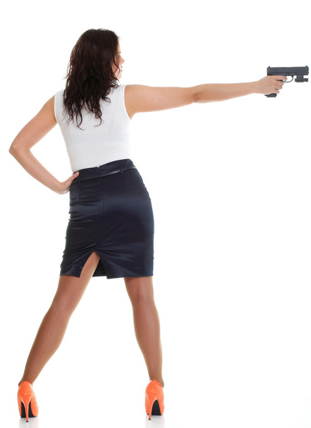 Young brunette woman with gun isolated on white - Fotó, kép