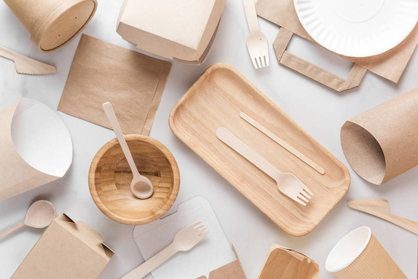 Eco friendly dishes. Disposable paper cups, dishes, fast food containers, wooden bowl and bamboo cutlery. flat lay - Photo, Image