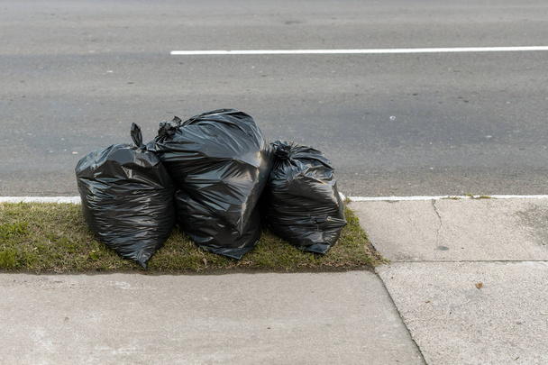 Plastic trash bags on street - Foto, immagini