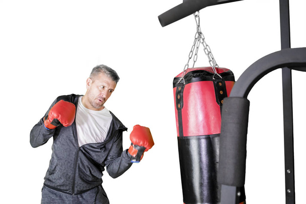 Caucasian man hitting on a boxing bag  - Zdjęcie, obraz