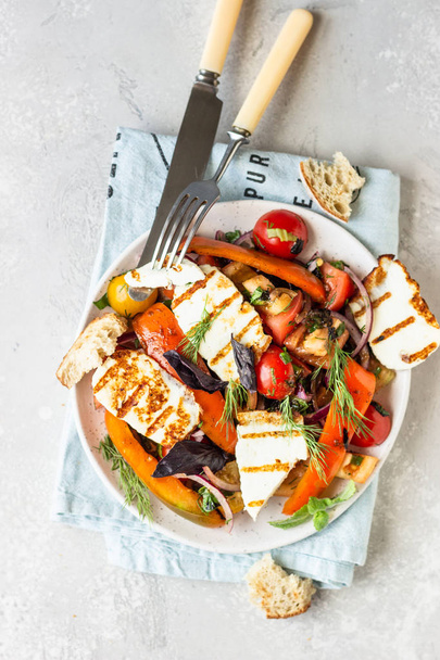 Tomato, baked pepper and onion salad with grilled haloumi cheese (halloumi). Keto diet, healthy food. - Photo, image