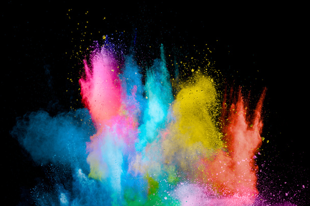 Explosion of colorful Holi powder on black background. Vibrant color dust particles textured background. - Fotoğraf, Görsel