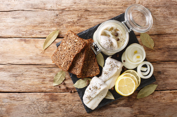 Baltic pickled herring with onions in a glass jar close-up on th - Photo, Image