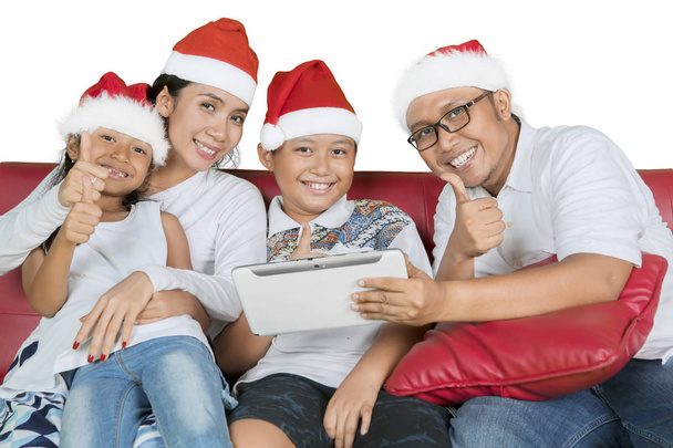 Smiling family with thumbs and tablet at Christmas - Φωτογραφία, εικόνα