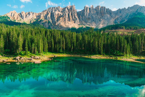 Beautiful turquoise Alpine lake Carezza or Lago di Carezza in Dolomites mountains, South Tyrol, Italy - Photo, Image