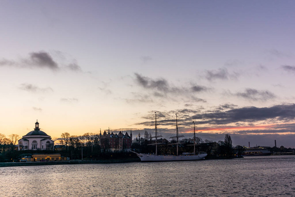 An old white sailing ship  in Stockholm during a colorful sunrise  - Fotó, kép