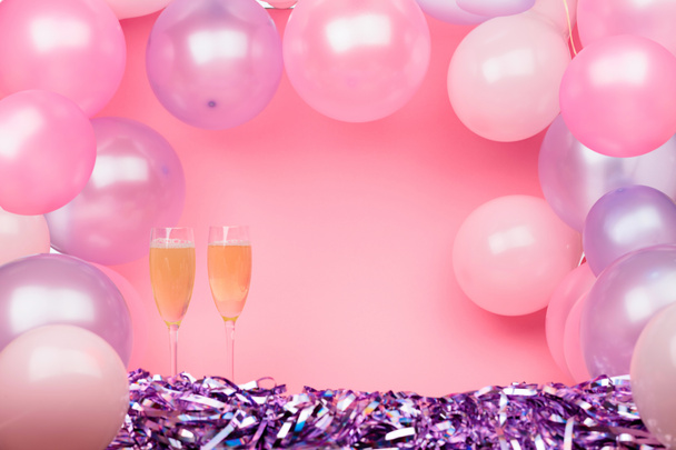 Dos copas de champán sobre fondo rosa con rosa y purp
 - Foto, imagen