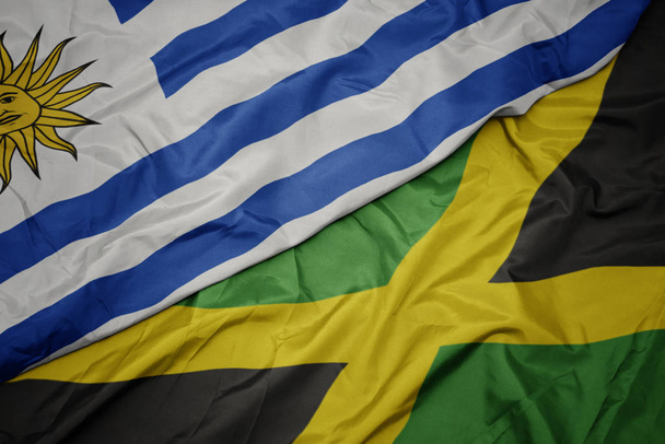 schwenken bunte jamaikanische und uruguayische Nationalflagge. - Foto, Bild