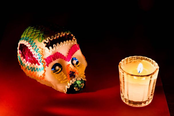 Sugar skull and candle close up  - Photo, Image
