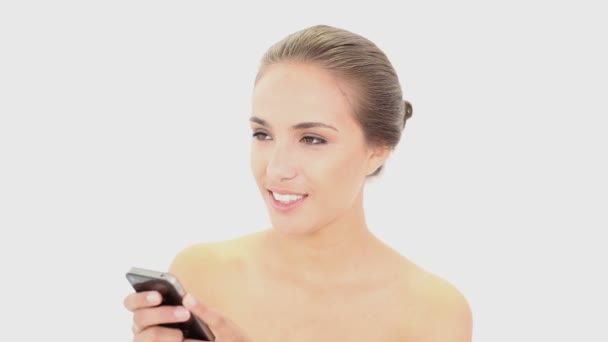 Beautiful model texting on her smartphone - Materiaali, video