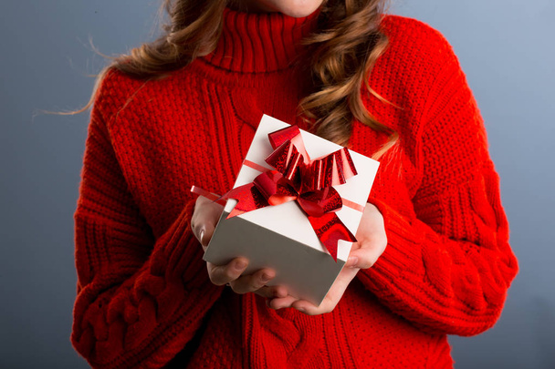 Close up view of hands are giving a beautiful gift box to you, f - 写真・画像