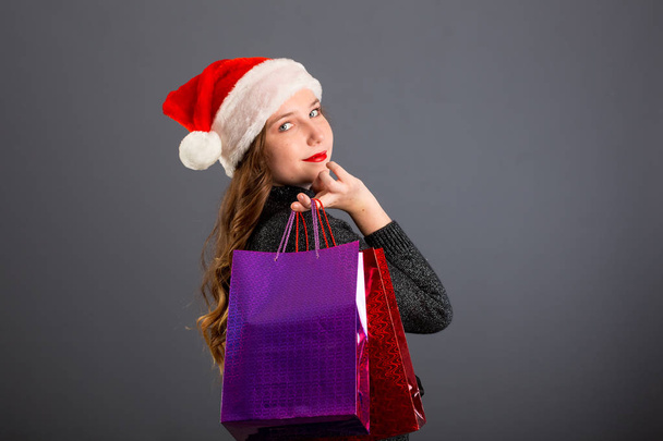 Woman shopping for christmas gifts. Young caucasian girl looking - Photo, Image