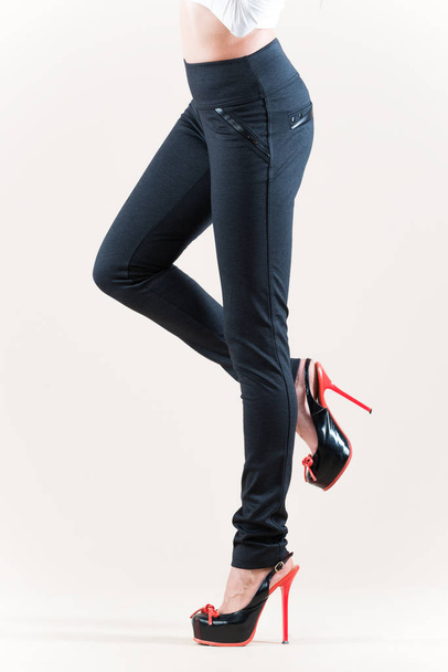 Beautiful slim female legs in beige high heel - Фото, изображение