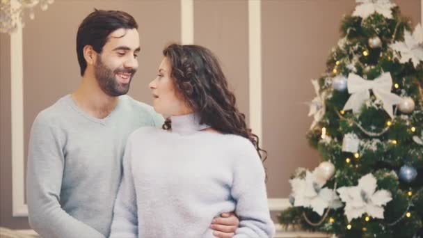 Young happy couple singing carols on Christmas Eve. - Πλάνα, βίντεο