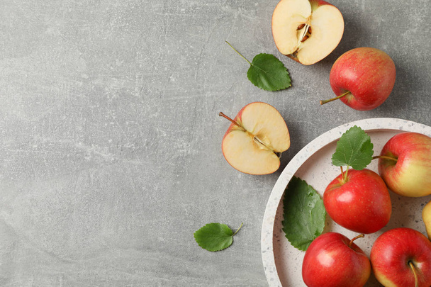 Red apples on grey background, top view - Valokuva, kuva