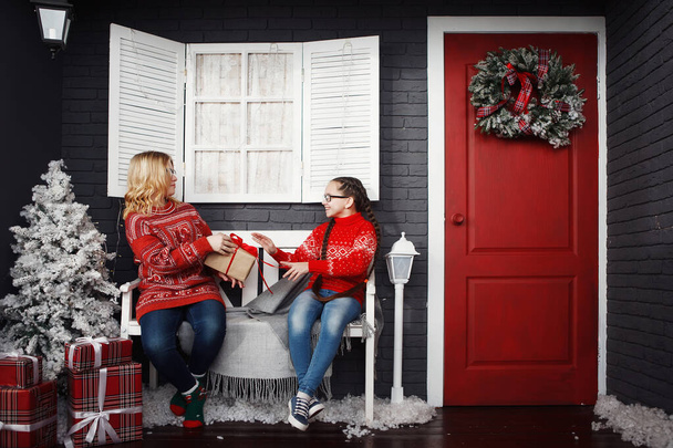 Teenage girls in a red Christmas sweater. - Zdjęcie, obraz