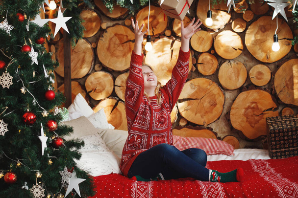 Nastolatka w czerwonym swetrze świątecznym. - Zdjęcie, obraz