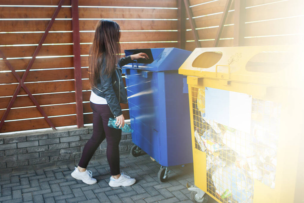 Woman throwing plastic cup into trash can. - Fotografie, Obrázek