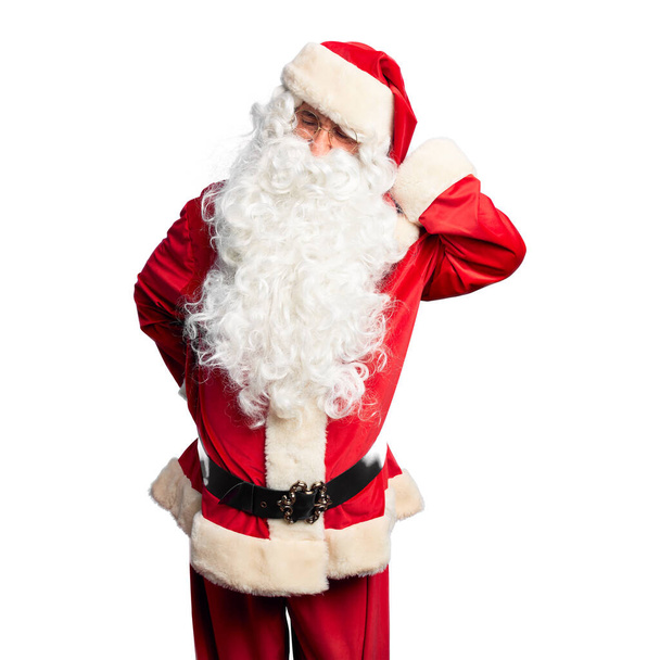 Homem bonito de meia idade vestindo traje de Papai Noel e barba de pé Sofrendo de lesão no pescoço, tocando o pescoço com a mão, dor muscular
 - Foto, Imagem