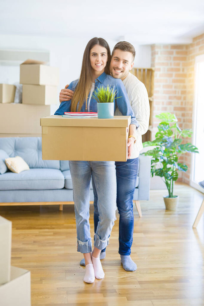 Beautiful young couple moving to a new house, smiling happy hold - Fotoğraf, Görsel