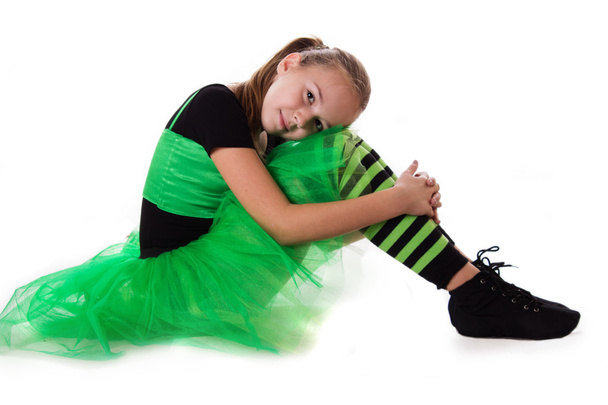 Little dancer in green tutu skirt sitting - Foto, imagen