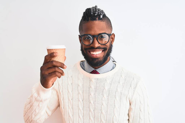 African american man with braids drinking take away coffee over isolated white background with a happy face standing and smiling with a confident smile showing teeth - 写真・画像