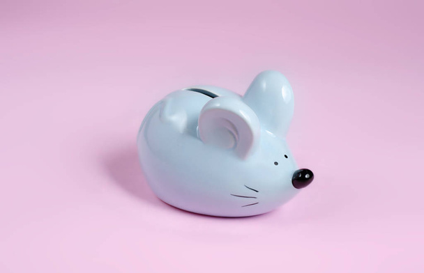blue piggy bank in the shape of a mouse on a pink background - Fotografie, Obrázek