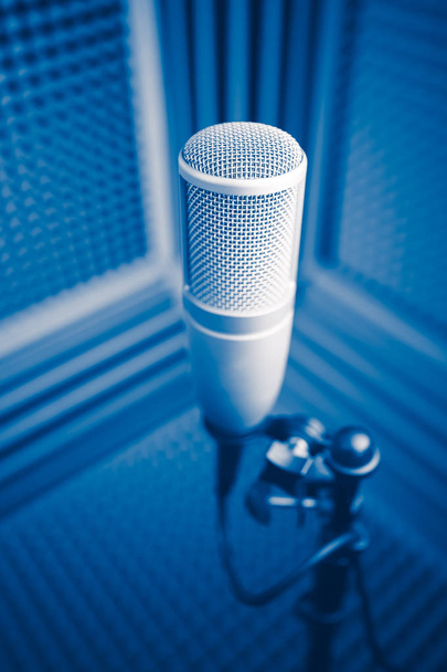 professional microphone in sound recording studio, blue acoustic foam background - Photo, Image
