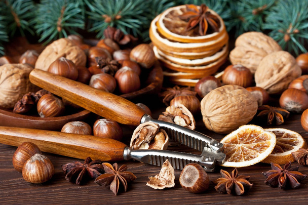 Christmas still life  with spices, nuts and dried oranges on wooden table - Foto, Bild