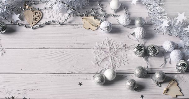 Christmas background of silver tinsel, beads, wooden Christmas t - Foto, immagini