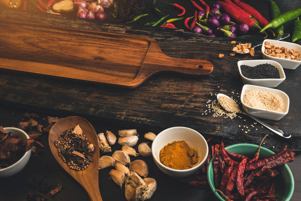 Spices for use as cooking ingredients on a wooden background with Fresh organic vegetables on wood. Healthy food herbs and spices. Organic vegetables on rustic wood. - 写真・画像
