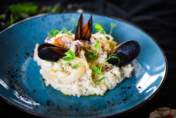 tasty seafood risotto with fresh vegetables & herbs - octopus, shrimps, shells, squid & prawns mixed with special vegetables & herbs dressing - Photo, Image