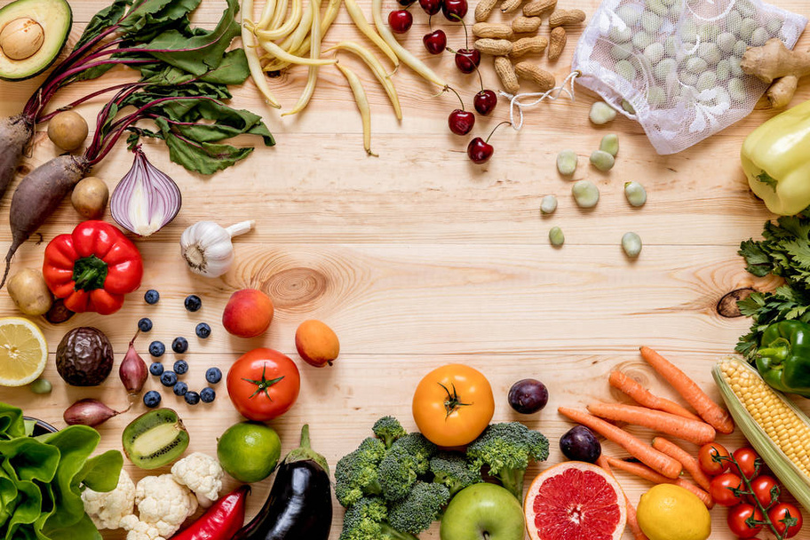 Modern composition of fresh healthy vegetables and fruits on the wooden table in the kitchen. Healthy detox and balance diet. Lifestyle. Vegetarian vegan background. Zero waste. Top view. Copy space. - 写真・画像