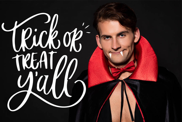happy man with vampire costume isolated on black with trick or treat illustration  - Foto, Imagem