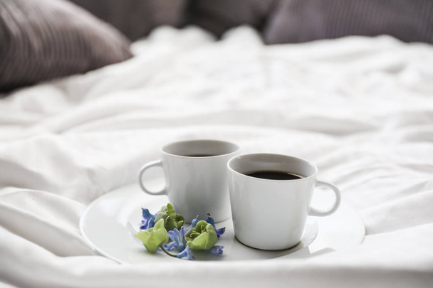 Good romantic morning with a coffee in bed. Two white cups of coffee on the bed - Foto, Imagem