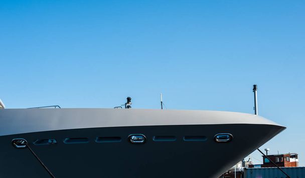 The bow of a grey yacht at port. - Photo, Image