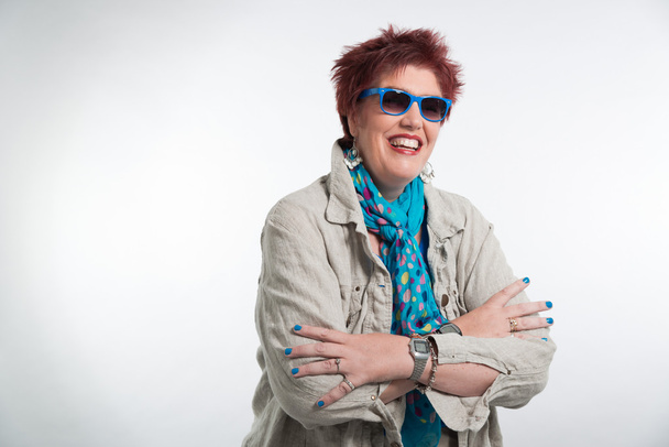 Happy smiling middle aged woman with red short hair. Wearing sun - Fotó, kép
