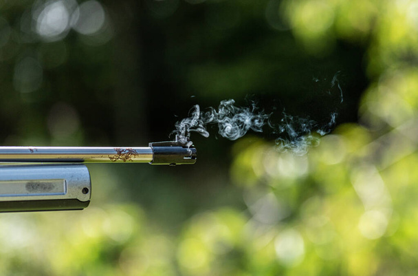 Gas coming out of the muzzle of a BB air pistol. - Photo, Image