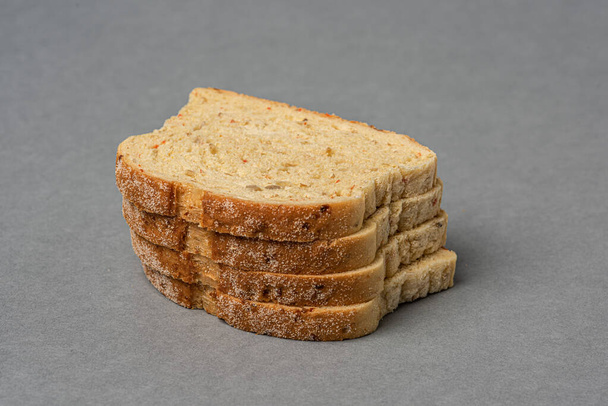 Four slices of bread on grey background - Photo, Image