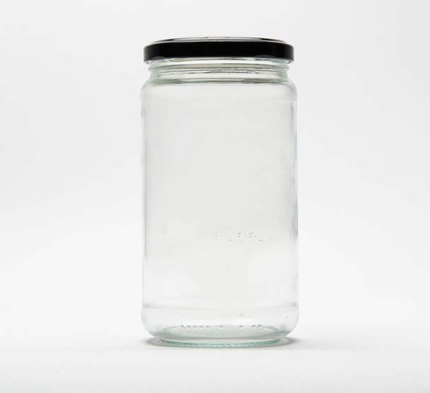 Empty glass jar with a black lid on white background. - Photo, Image