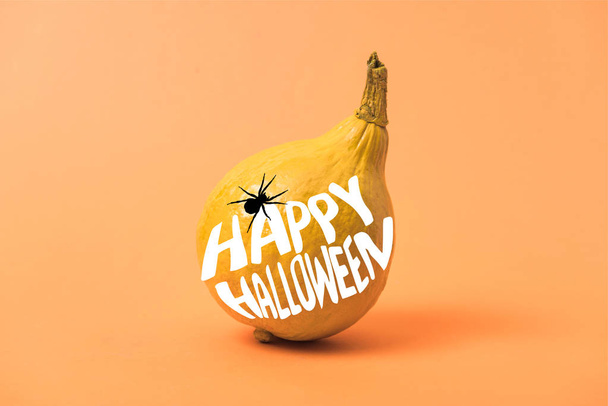 painted yellow Halloween pumpkin on orange colorful background with spider and happy Halloween illustration - Photo, Image