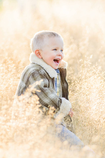 Happy cheerful smiling blond boy on farm - Foto, afbeelding