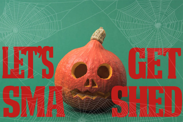 spooky Halloween pumpkin on green background with lets get smashed illustration - Photo, image
