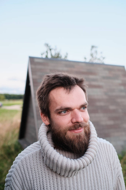 bearded man in a sweater with a throat on nature. Hipster. Forester. huntsman - Fotoğraf, Görsel