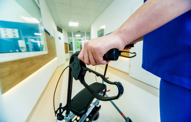 Patient on rollator with hand brakes moving in hospital. Medical concept - Photo, Image