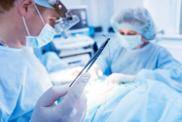 Spinal surgery. Group of surgeons in operating room with surgery equipment. Laminectomy. Modern medical background - Photo, Image