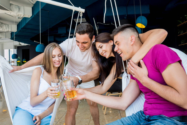 Cheerful friends in the pub. Drinking beer, talking, having fun. Meeting friends after work - Foto, imagen
